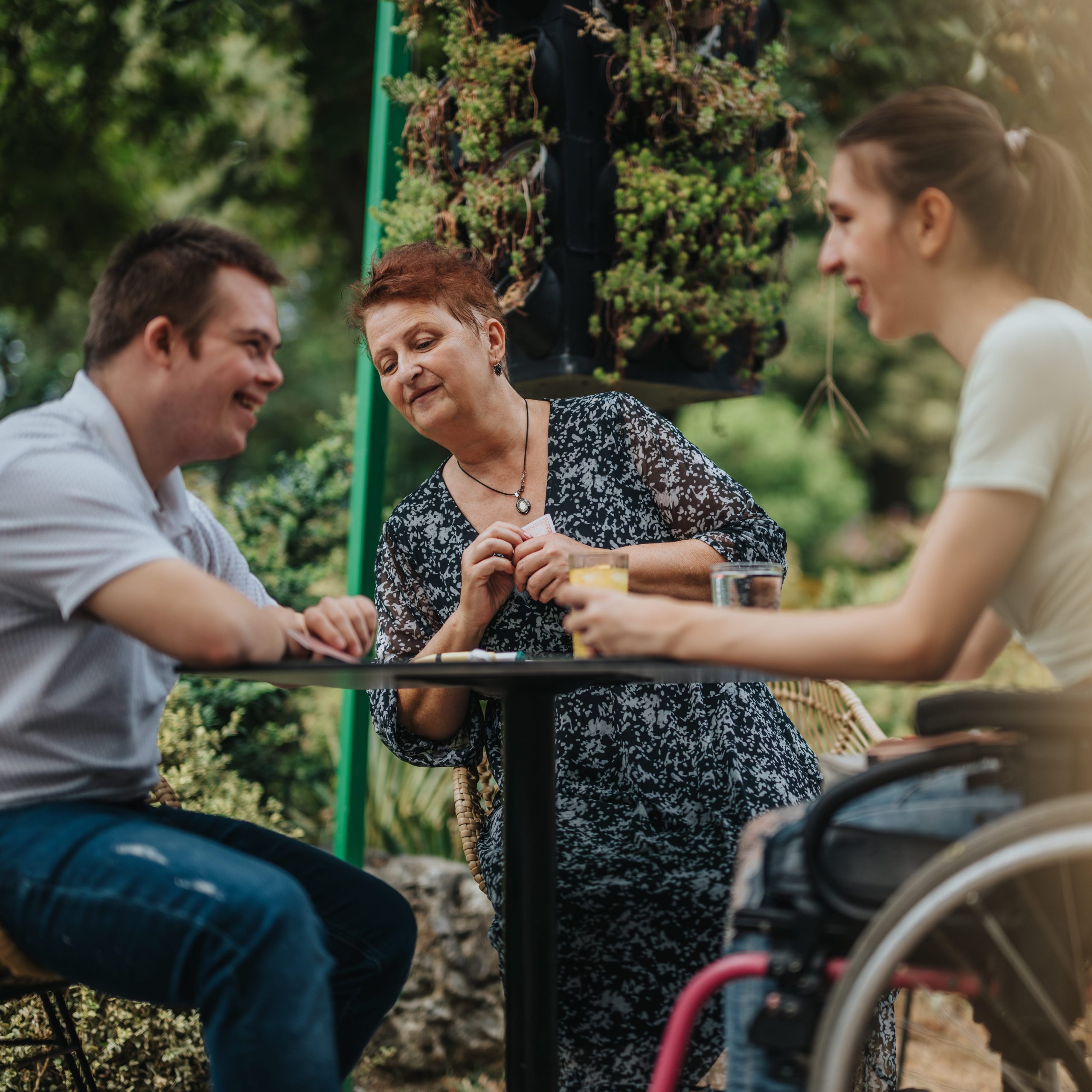 Friends enjoying conversation at an outdoor cafe setting